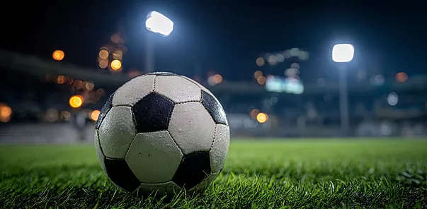 1xBet logo with close-up football on field